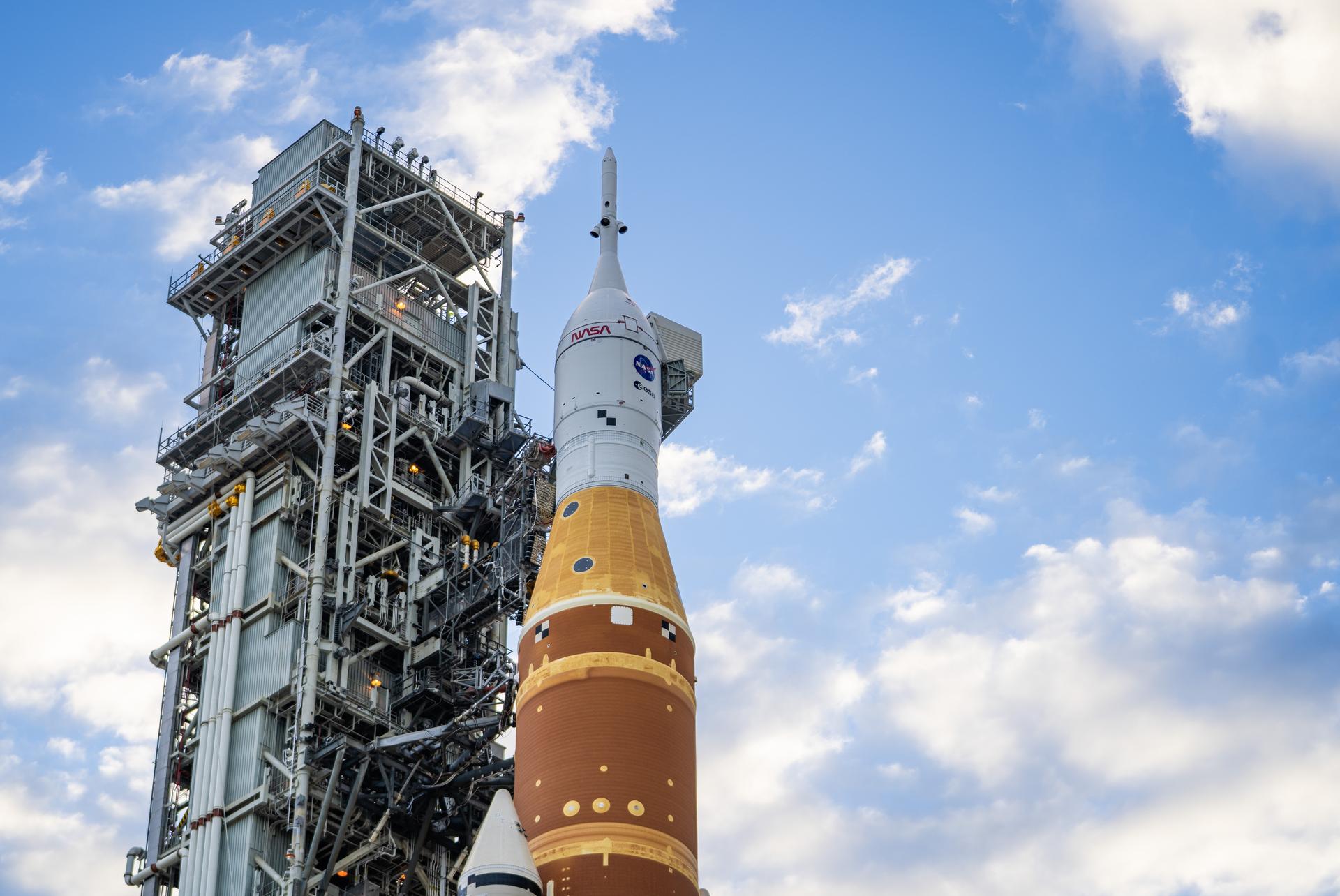 This image shows NASA’s SLS (Space Launch System) and Orion spacecraft rolling out of the Vehicle Assembly Building at NASA’s Kennedy Space Center. NASA's massive Crawler-Transporter, upgraded for the Artemis program, carries the powerful SLS rocket and Orion spacecraft on the Mobile Launcher from the Vehicle Assembly Building to Launch Pad 39B at Kennedy Space Center   in preparation for the Artemis II mission. 